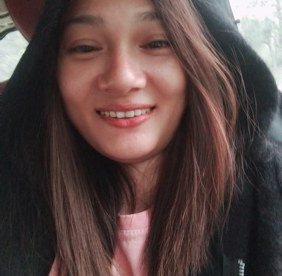A digital marketer, content creator, & SEO expert with long brown hair wearing a black hoodie and a pink top.